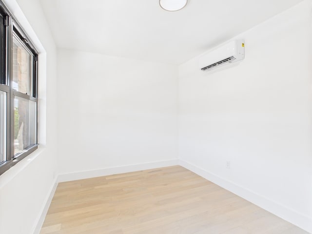 1310 E 223rd St, Bronx, NY 10466 - unfurnished room featuring a wall unit AC and light wood finished floors