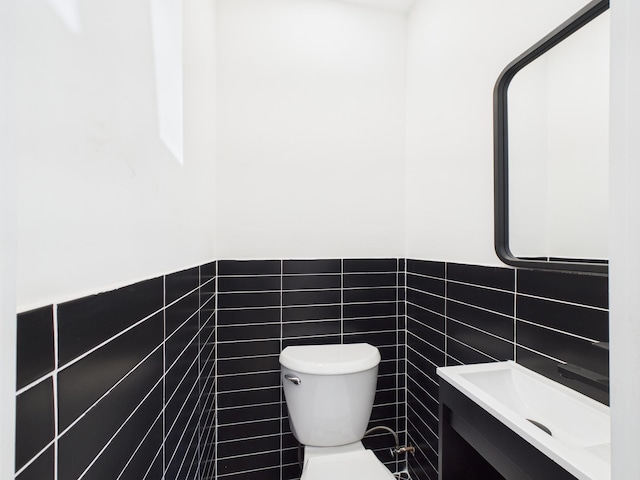 1310 E 223rd St, Bronx, NY 10466 - half bath with tile walls, vanity, and a wainscoted wall