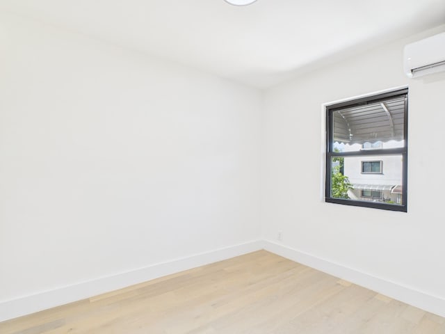 1310 E 223rd St, Bronx, NY 10466 - spare room with a wall mounted AC and light wood finished floors