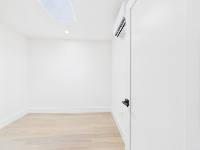 1310 E 223rd St, Bronx, NY 10466 - spacious closet featuring a skylight, a wall unit AC, and light wood-type flooring