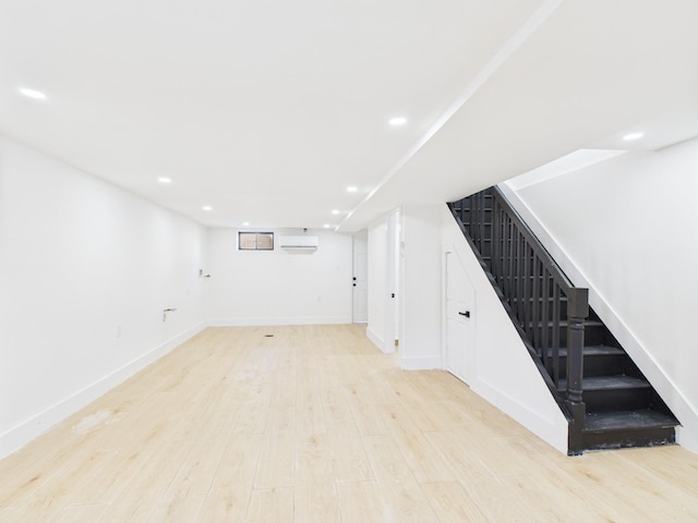 1310 E 223rd St, Bronx, NY 10466 - finished basement with a wall mounted AC, light wood-style flooring, stairs, and recessed lighting