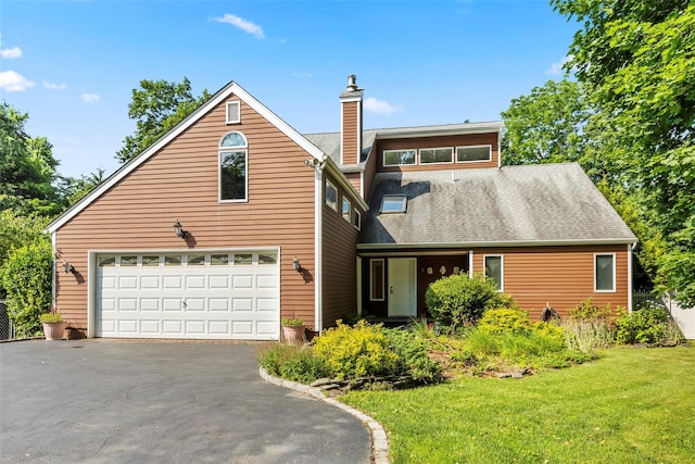 8 Braemer Rd, East Setauket, NY 11733 - view of front of house with a chimney, a front yard, a garage, driveway, and a shingled roof