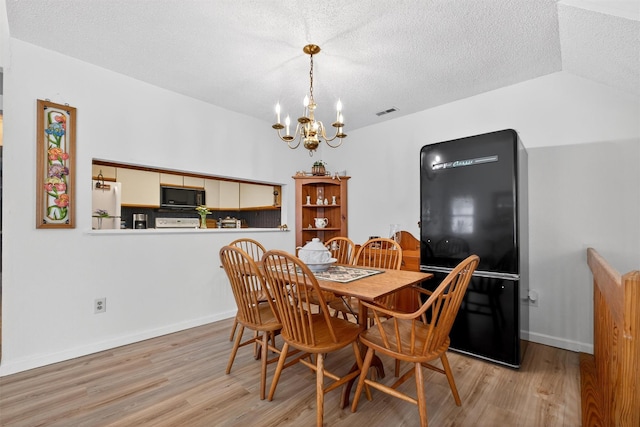 41 Millholland Dr, Fishkill, NY 12524 - dining space with a chandelier, light wood-style flooring, and a textured ceiling