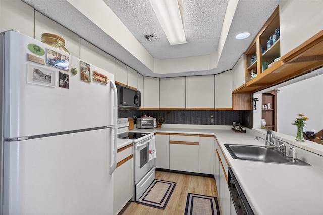 41 Millholland Dr, Fishkill, NY 12524 - kitchen featuring white appliances, a textured ceiling, light wood finished floors, light countertops, and white cabinets