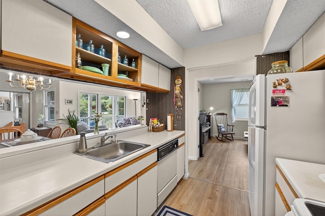 41 Millholland Dr, Fishkill, NY 12524 - kitchen with white appliances, light countertops, light wood-style flooring, a chandelier, and white cabinetry