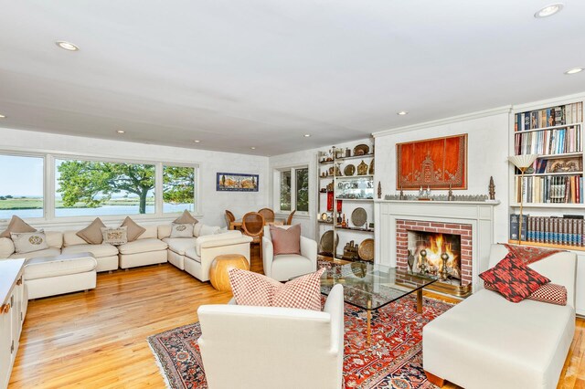 5 Shore Dr, Setauket, NY 11733 - living area featuring wood finished floors, a brick fireplace, recessed lighting, and a water view