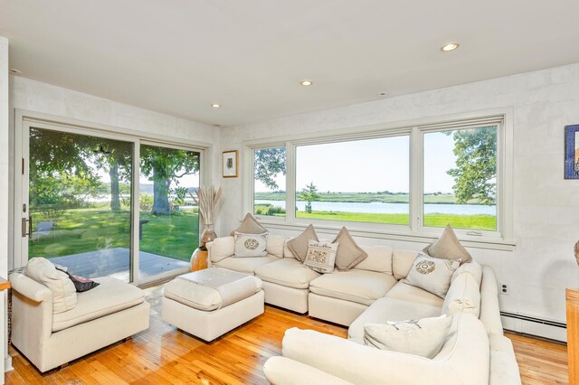 5 Shore Dr, Setauket, NY 11733 - living room featuring baseboard heating, healthy amount of natural light, a water view, wood finished floors, and recessed lighting