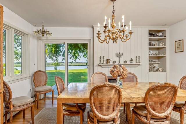 5 Shore Dr, Setauket, NY 11733 - dining room featuring a chandelier, wood finished floors, a water view, and built in features