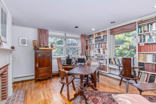 5 Shore Dr, Setauket, NY 11733 - office area with baseboard heating, a brick fireplace, hardwood / wood-style flooring, and healthy amount of natural light