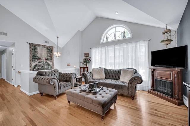 5 Thompson Ct, Campbell Hall, NY 10916 - living room featuring high vaulted ceiling, a chandelier, light wood finished floors, and a fireplace