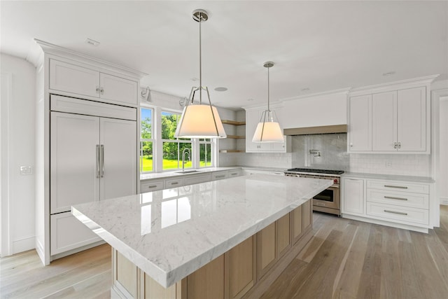 161 S Rd, Westhampton, NY 11977 - kitchen featuring high quality appliances, backsplash, light wood finished floors, and white cabinets
