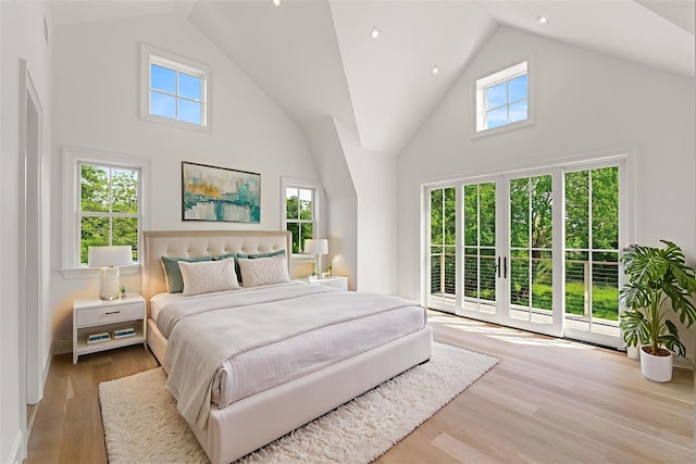 161 S Rd, Westhampton, NY 11977 - bedroom with access to outside, high vaulted ceiling, multiple windows, and wood finished floors