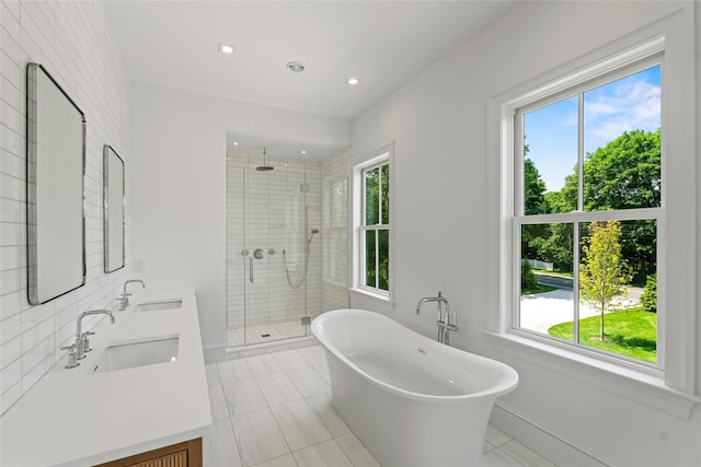 161 S Rd, Westhampton, NY 11977 - full bathroom with a shower stall, double vanity, a freestanding tub, tile patterned flooring, and recessed lighting