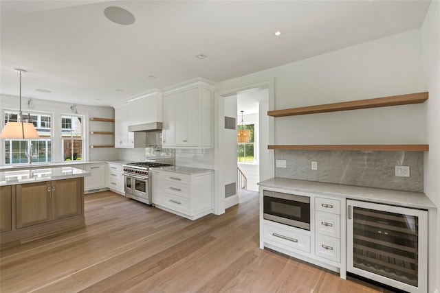 161 S Rd, Westhampton, NY 11977 - kitchen with open shelves, beverage cooler, appliances with stainless steel finishes, and plenty of natural light