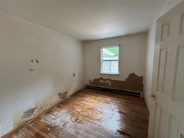 291 Locust Dr, Rocky Point, NY 11778 - empty room with wood-type flooring and a baseboard radiator