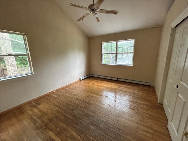 291 Locust Dr, Rocky Point, NY 11778 - empty room with a baseboard heating unit, hardwood / wood-style floors, lofted ceiling, and ceiling fan