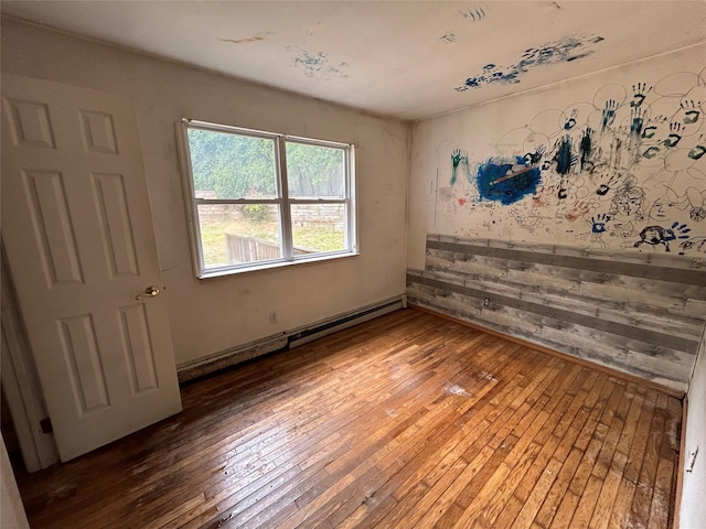 291 Locust Dr, Rocky Point, NY 11778 - spare room featuring baseboard heating and hardwood / wood-style floors