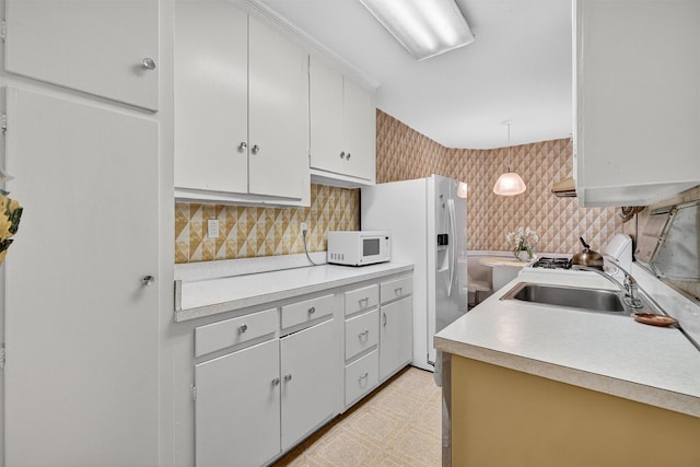 517 Riverdale Ave Unit 4A, Yonkers, NY 10705 - kitchen with white appliances, light countertops, light floors, decorative backsplash, and wallpapered walls
