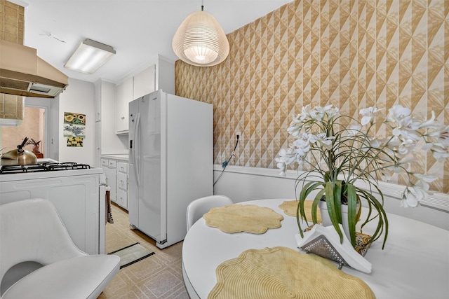 517 Riverdale Ave Unit 4A, Yonkers, NY 10705 - kitchen with white appliances, wallpapered walls, white cabinets, light flooring, and range hood