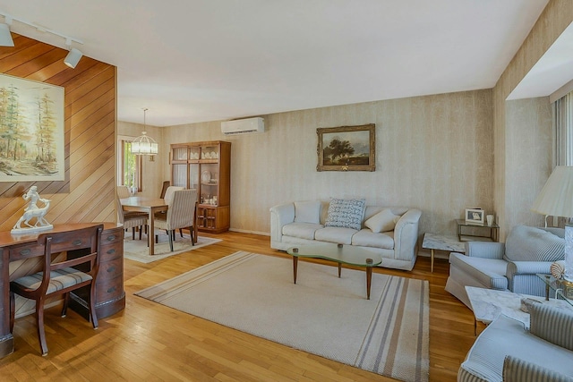 45 Colony Ln, Syosset, NY 11791 - living room with an AC wall unit, wallpapered walls, rail lighting, and light wood-style floors