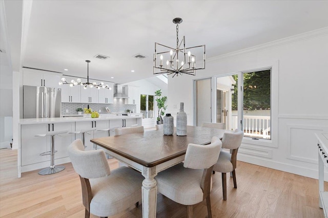 77 Bounty Ln, Jericho, NY 11753 - dining room with a chandelier, light wood-style flooring, recessed lighting, and crown molding