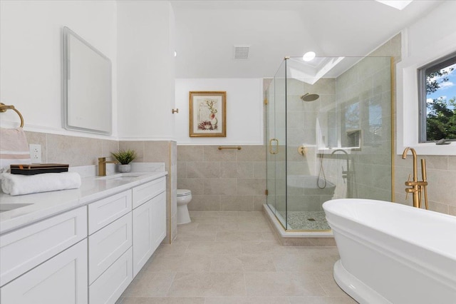 77 Bounty Ln, Jericho, NY 11753 - bathroom featuring tile walls, a freestanding tub, a stall shower, double vanity, and tile patterned floors