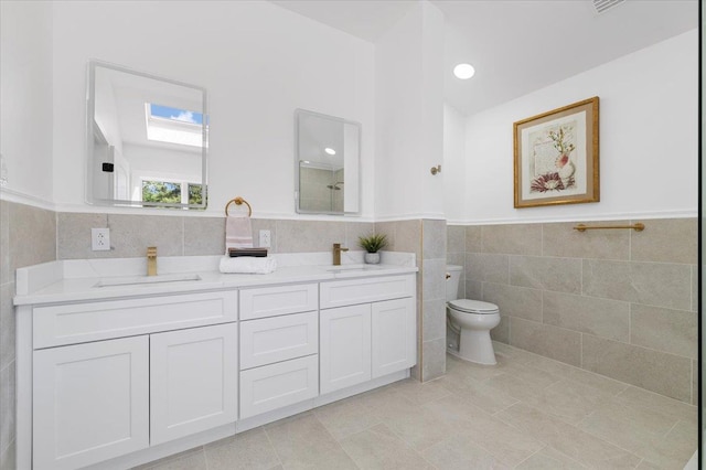 77 Bounty Ln, Jericho, NY 11753 - bathroom featuring tile walls, double vanity, tile patterned flooring, and wainscoting