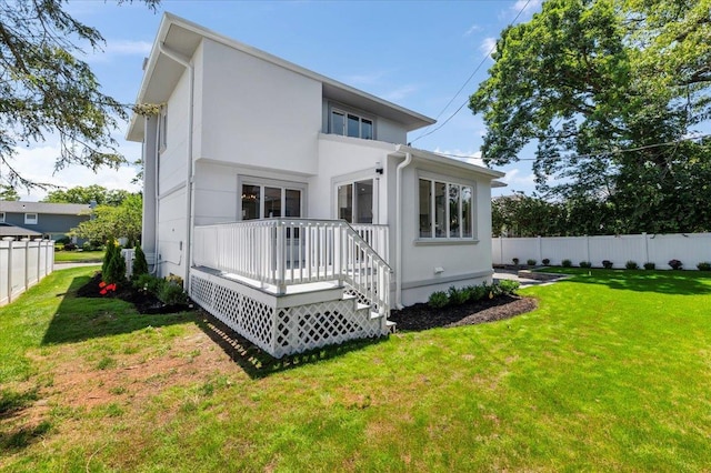 77 Bounty Ln, Jericho, NY 11753 - rear view of house with a wooden deck and stucco siding