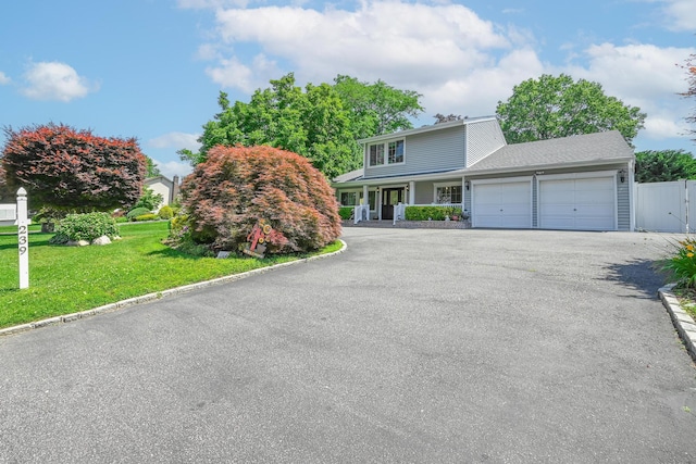 239 Walnut Rd, Glen Cove, NY 11542 - view of front facade featuring a garage and driveway