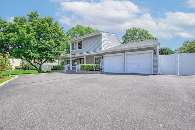 239 Walnut Rd, Glen Cove, NY 11542 - view of front of house with a porch, an attached garage, and driveway