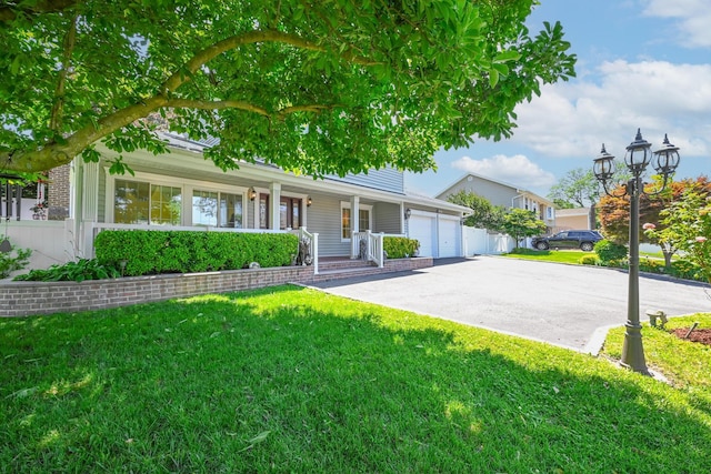 239 Walnut Rd, Glen Cove, NY 11542 - view of front of property featuring an attached garage, covered porch, a front lawn, and driveway