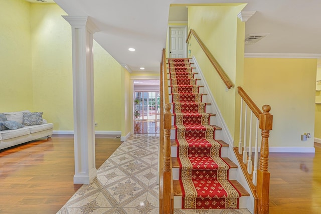 239 Walnut Rd, Glen Cove, NY 11542 - staircase with wood finished floors, ornamental molding, recessed lighting, and decorative columns