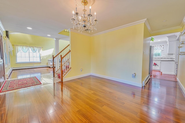 239 Walnut Rd, Glen Cove, NY 11542 - foyer entrance featuring stairs, crown molding, healthy amount of natural light, wood finished floors, and a chandelier