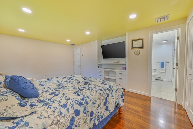 239 Walnut Rd, Glen Cove, NY 11542 - bedroom with hardwood / wood-style flooring, recessed lighting, and ensuite bathroom