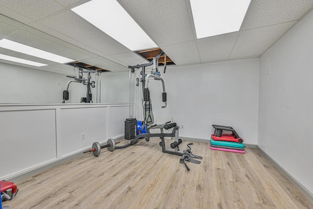 239 Walnut Rd, Glen Cove, NY 11542 - workout area featuring wood finished floors and a paneled ceiling