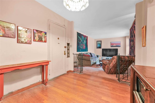 26-20 141st St Unit 2G, Flushing, NY 11354 - foyer with light wood finished floors and a chandelier