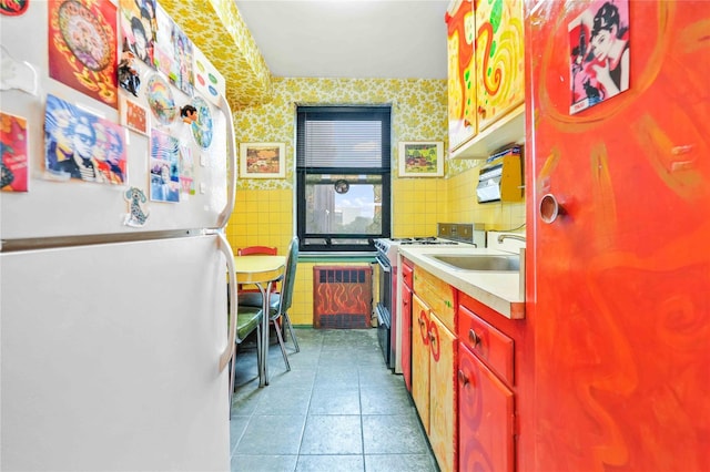 26-20 141st St Unit 2G, Flushing, NY 11354 - kitchen with freestanding refrigerator, range with gas cooktop, tile patterned flooring, light countertops, and wallpapered walls