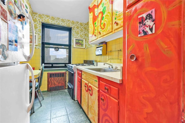 26-20 141st St Unit 2G, Flushing, NY 11354 - kitchen featuring freestanding refrigerator, gas range, light countertops, tile patterned flooring, and wallpapered walls