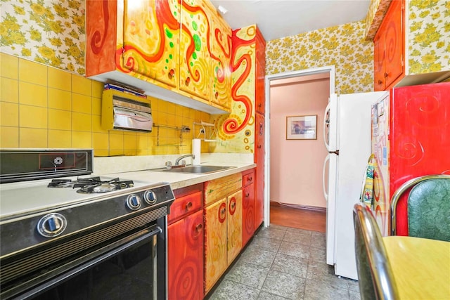 26-20 141st St Unit 2G, Flushing, NY 11354 - kitchen with range with gas stovetop, wallpapered walls, freestanding refrigerator, and light countertops