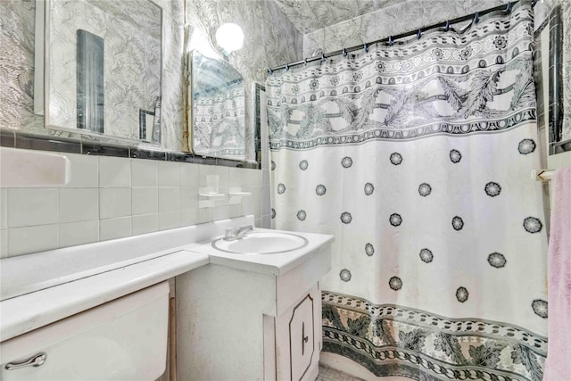 26-20 141st St Unit 2G, Flushing, NY 11354 - bathroom with vanity, decorative backsplash, a shower with curtain, and tile walls