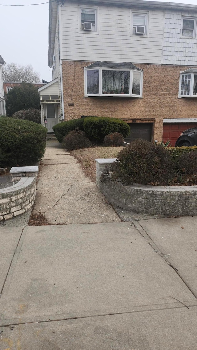 66 Paerdegat 1st St, Brooklyn, NY 11236 - view of side of property with a garage and brick siding