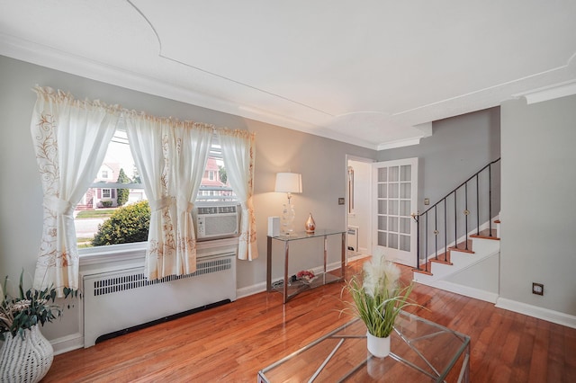 662 Rose Blvd, Baldwin, NY 11510 - living area with radiator, wood finished floors, stairway, and crown molding