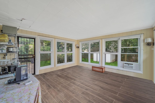 662 Rose Blvd, Baldwin, NY 11510 - sunroom featuring a wood stove, a deck, healthy amount of natural light, and wood finished floors