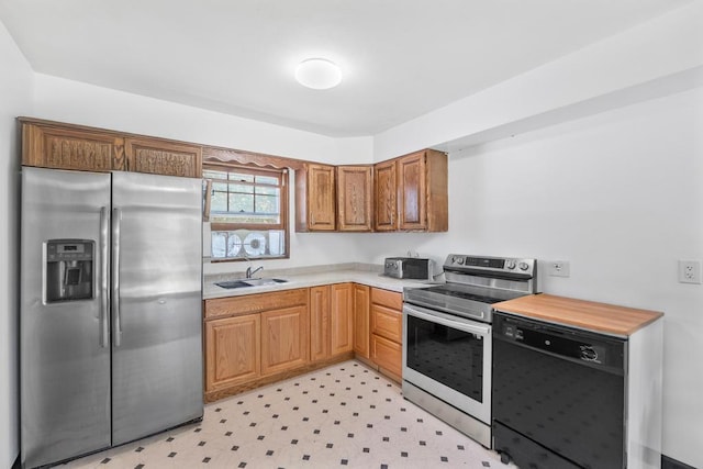 565 Barley Ln, Southold, NY 11971 - kitchen featuring stainless steel appliances, light countertops, light floors, and brown cabinetry