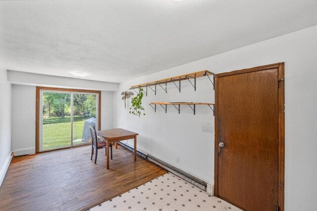 565 Barley Ln, Southold, NY 11971 - dining room featuring baseboard heating and wood finished floors