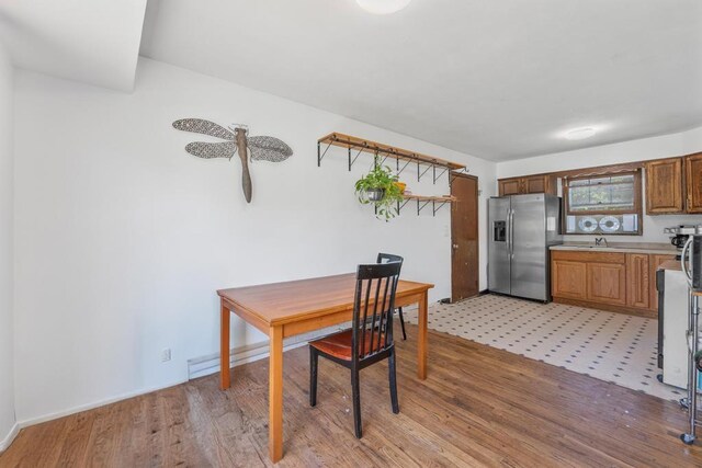 565 Barley Ln, Southold, NY 11971 - kitchen with stainless steel fridge, light countertops, and light wood-style floors