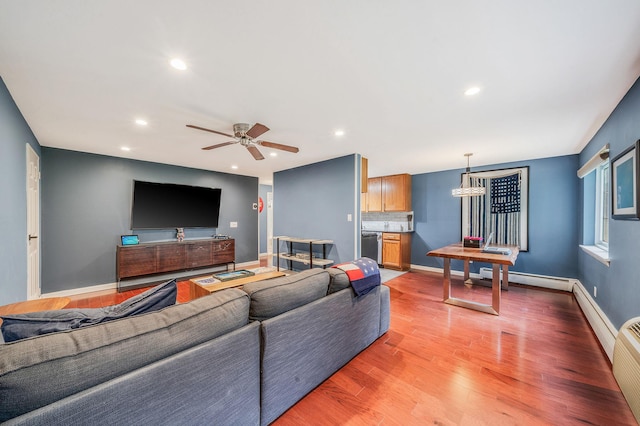 114 Jervis Ave Unit 114, Farmingdale, NY 11735 - living area featuring baseboard heating, recessed lighting, light wood-style flooring, and a ceiling fan