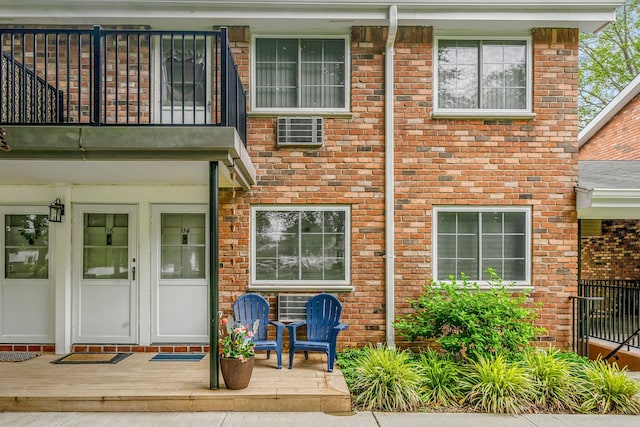 114 Jervis Ave Unit 114, Farmingdale, NY 11735 - view of exterior entry with a balcony and brick siding