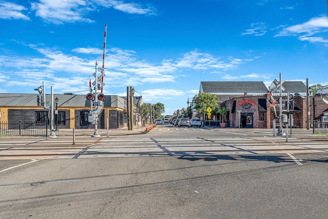 114 Jervis Ave Unit 114, Farmingdale, NY 11735 - view of asphalt road with sidewalks, curbs, street lights, traffic signs, and traffic lights