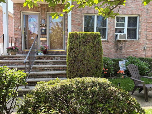 4218 217th St, Bayside, NY 11361 - entrance to property featuring brick siding and cooling unit